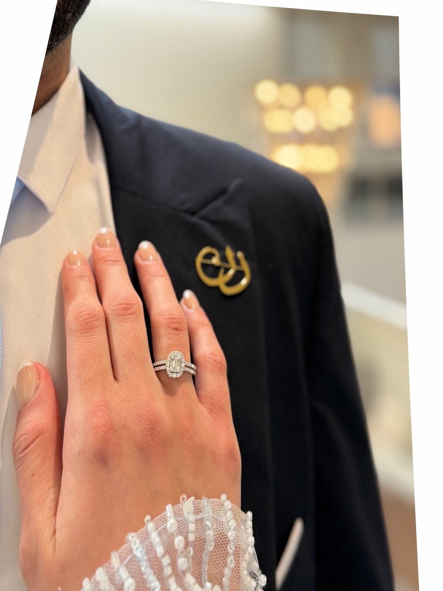 Engagement ring close-up on a groom’s suit, photographed by Kamar photography