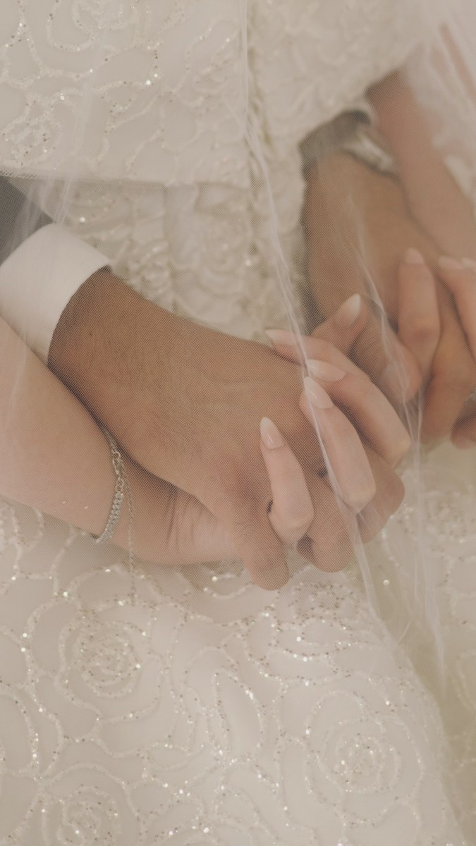 Bride and groom holding hands, photographed by Kamar photography