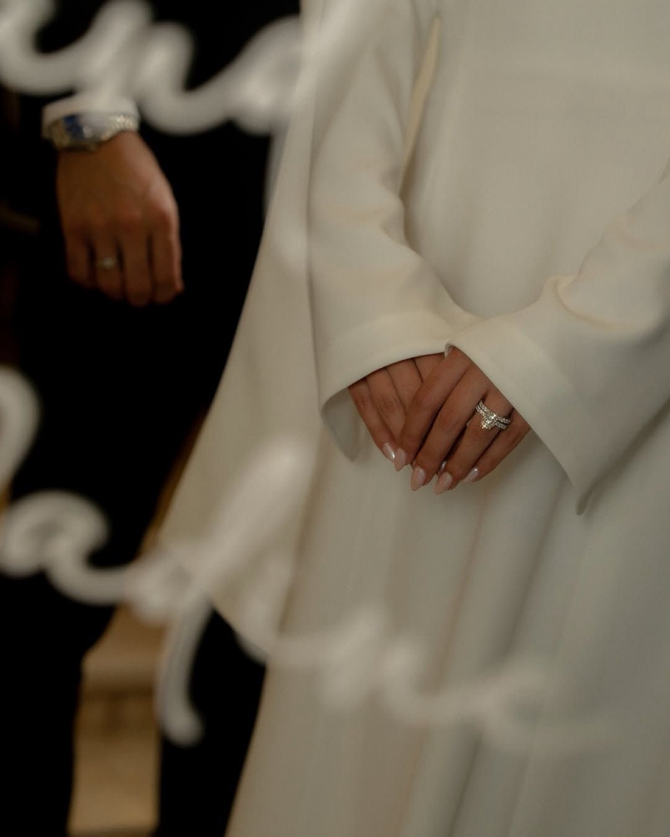 Close-up of the bride's hands with her ring, with the groom's hand beside her, photographed by Kamar photography