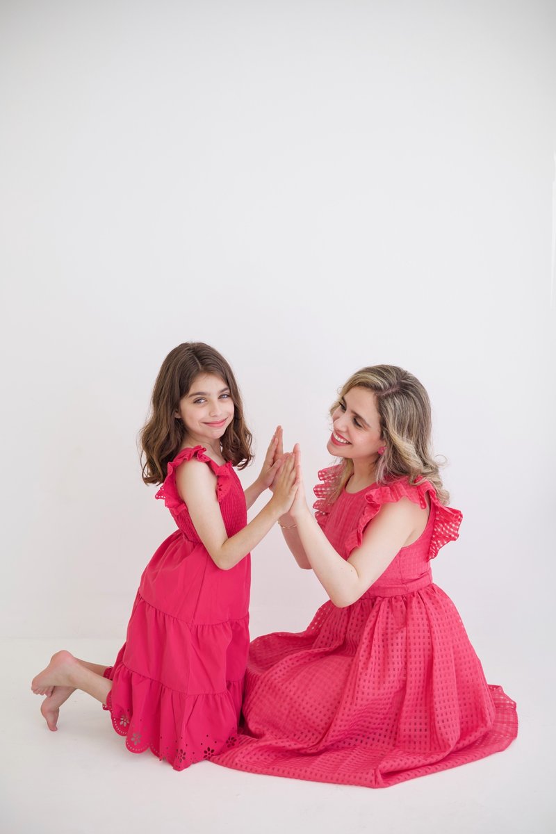 Mai Tahrawi with her daughter in matching pink dresses